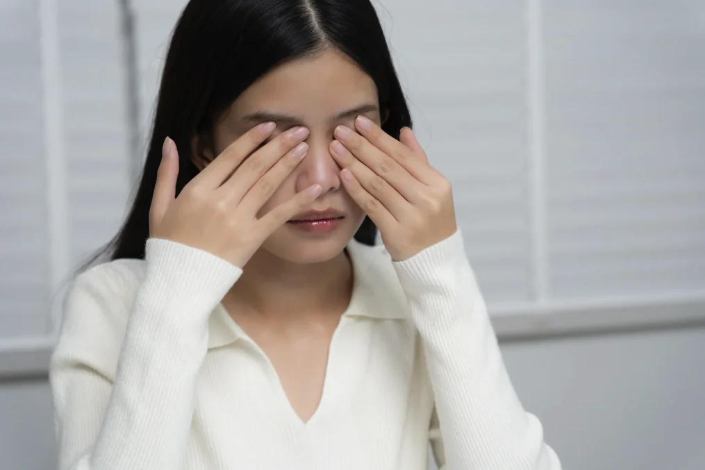 Asian woman rubbing her dry eyes