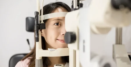 Young Asian woman undergoing a slit lamp exam during a glaucoma screening in Singapore.